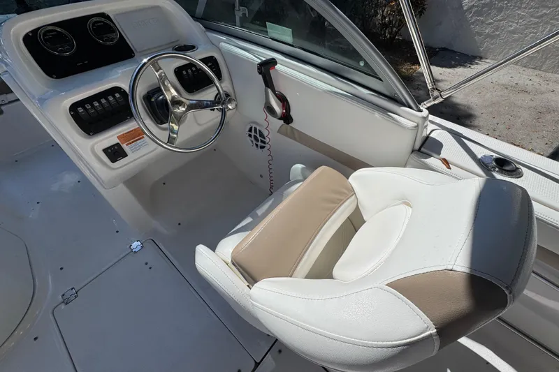 Slide: The Image of 2022 Robalo R207 Dual Console boat interior with steering wheel and captain's chair. - 9