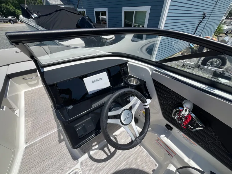 Slide: The Image of The image shows the cockpit of a Sea Ray SPX 210 Outboard boat with a modern helm. - 9