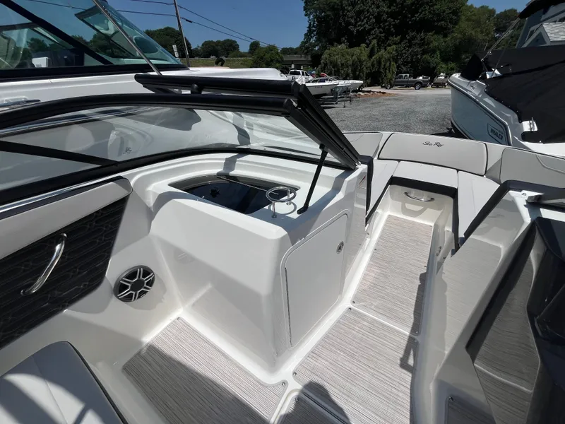 Slide: The Image of The image shows the cockpit of a Sea Ray SPX 210 Outboard boat with modern seating. - 10