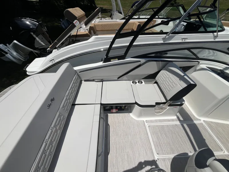 Slide: The Image of The image shows the deck of a Sea Ray SPX 210 Outboard boat with sleek seating. - 6