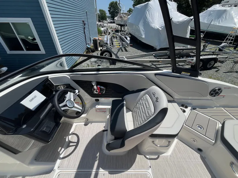 Slide: The Image of The image shows the cockpit of a Sea Ray SPX 210 Outboard boat with modern seating. - 7