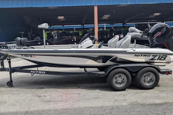 Slide: The Image of 2020 Nitro Z18 boat on trailer, parked in a marina, side view. - 11