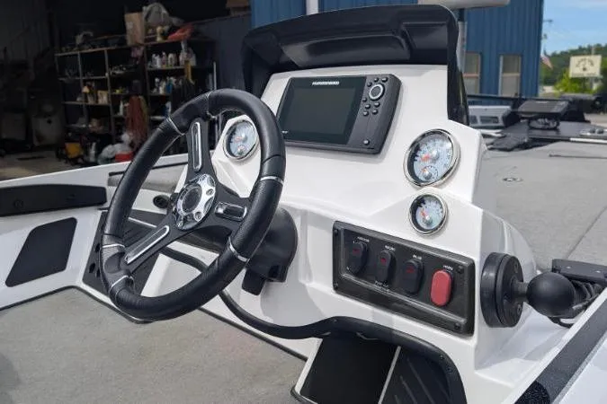Slide: The Image of 2020 Nitro Z18 boat dashboard with steering wheel, gauges, and electronic display. - 2