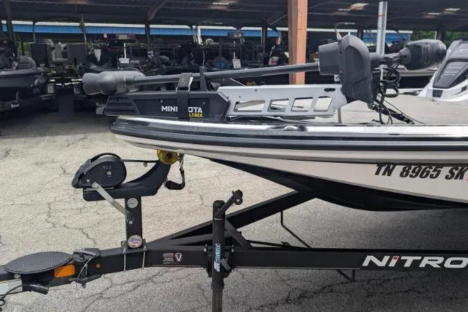 Slide: The Image of Nitro Z18 2020 boat with Minn Kota Ultrex motor on trailer in parking area. - 4