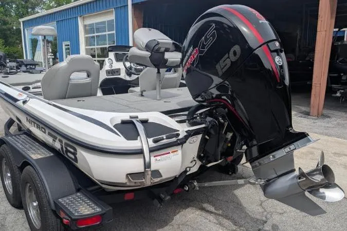 Slide: The Image of 2020 Nitro Z18 boat with powerful outboard motor, parked near a blue building. - 5
