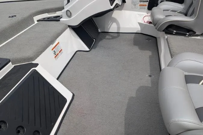 Slide: The Image of Interior of a 2020 Nitro Z18 boat with gray seating and carpeted flooring. - 8