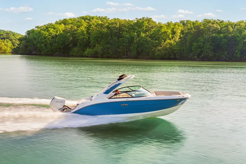Slide: The Image of 2026 Sea Ray SDX 230 Outboard cruising on a serene lake. - 2