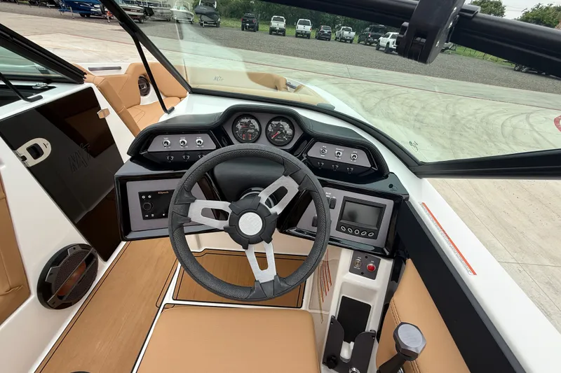 Slide: The Image of 2022 MasterCraft NXT22 boat dashboard with steering wheel, gauges, and control panel. - 10
