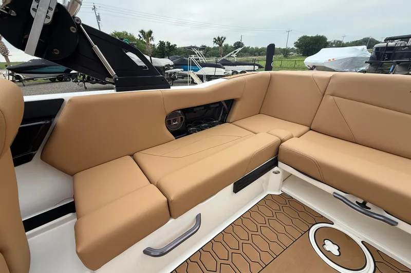 Slide: The Image of 2022 MasterCraft NXT22 boat interior with tan seating and stylish flooring. - 14