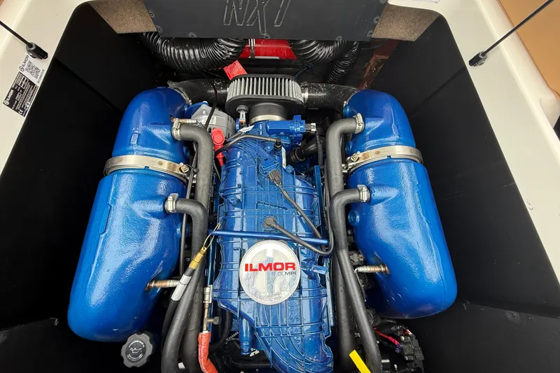 Slide: The Image of Engine of a 2022 MasterCraft NXT22 boat, featuring Ilmor branding and blue components. - 16
