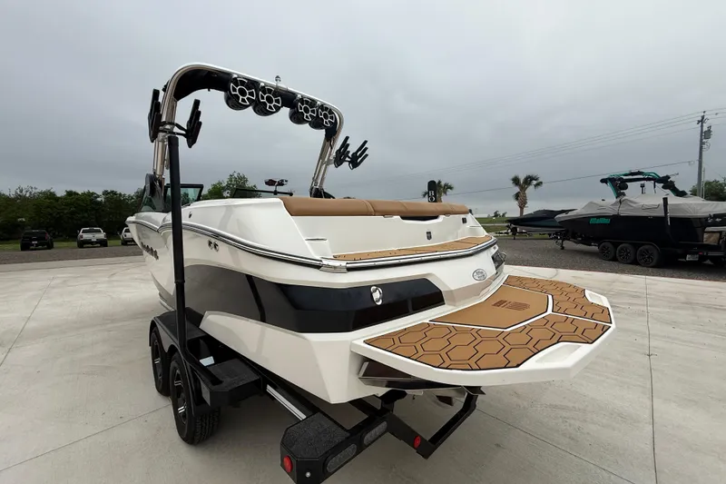 Slide: The Image of 2022 MasterCraft NXT22 boat on trailer, featuring sleek design and modern wakeboard tower. - 4