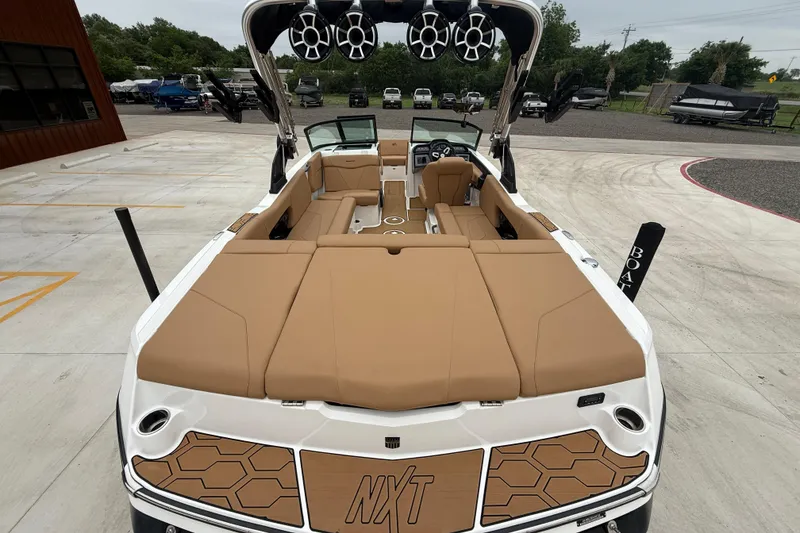 Slide: The Image of 2022 MasterCraft NXT22 boat with tan seating and modern design. - 7