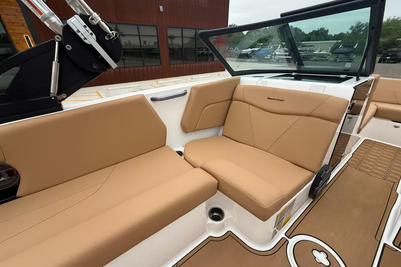 Slide: The Image of 2022 MasterCraft NXT22 boat interior with tan seating and sleek design. - 8