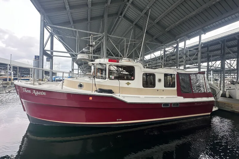 Slide: The Image of 2018 Ranger Tugs R-31 S boat docked under a covered marina. - 2