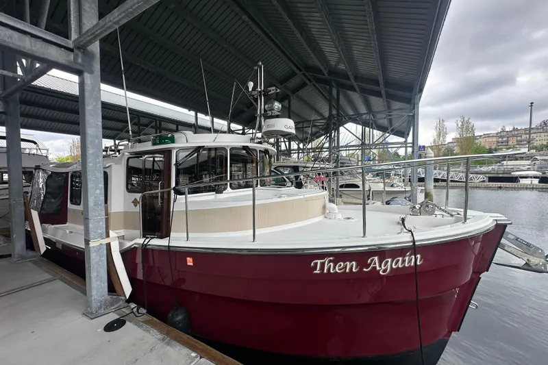 Slide: The Image of 2018 Ranger Tugs R-31 S boat named "Then Again" docked in a marina. - 21