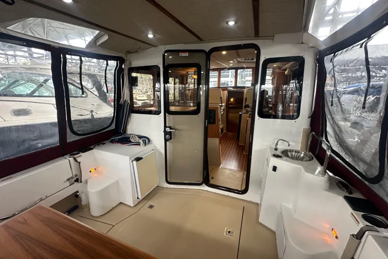 Slide: The Image of Interior view of 2018 Ranger Tugs R-31 S boat with seating and kitchenette. - 23
