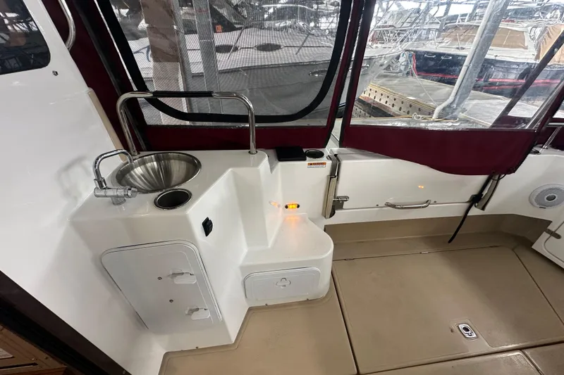 Slide: The Image of 2018 Ranger Tugs R-31 S boat interior with sink and storage compartments. - 24