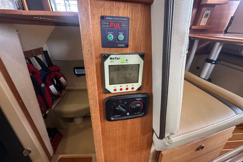 Slide: The Image of Control panel inside 2018 Ranger Tugs R-31 S boat cabin, featuring electronic displays and seating. - 29