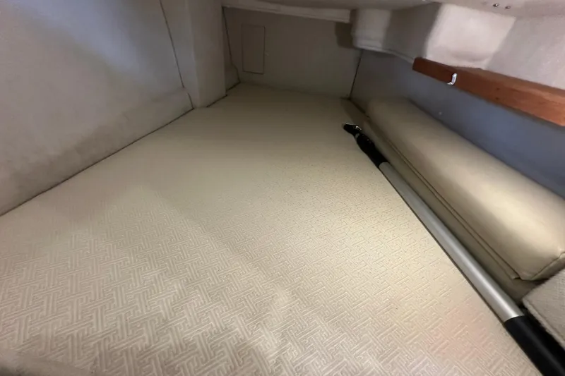 Slide: The Image of 2018 Ranger Tugs R-31 S interior cabin with beige upholstery and wooden accents. - 31