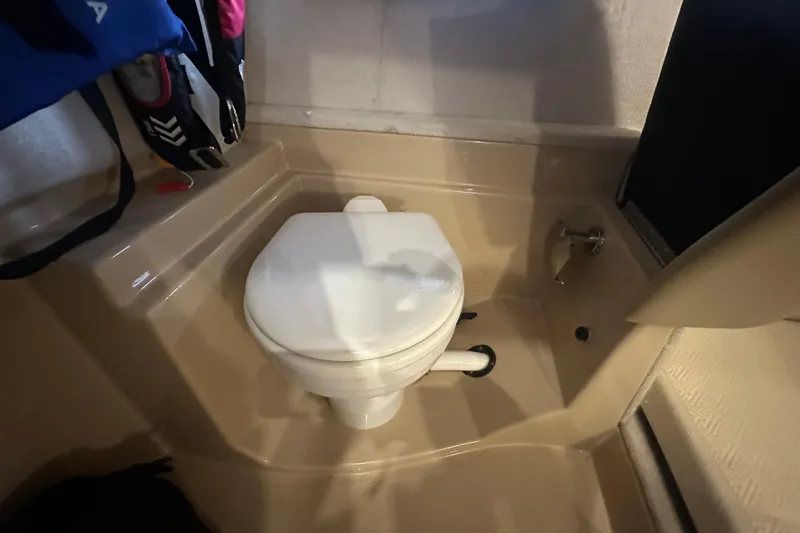 Slide: The Image of Compact bathroom in 2018 Ranger Tugs R-31 S boat, featuring a white toilet. - 33