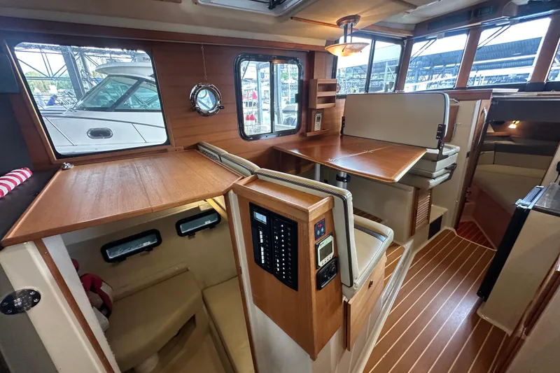 Slide: The Image of Interior of 2018 Ranger Tugs R-31 S, featuring wood finishes and seating area. - 34