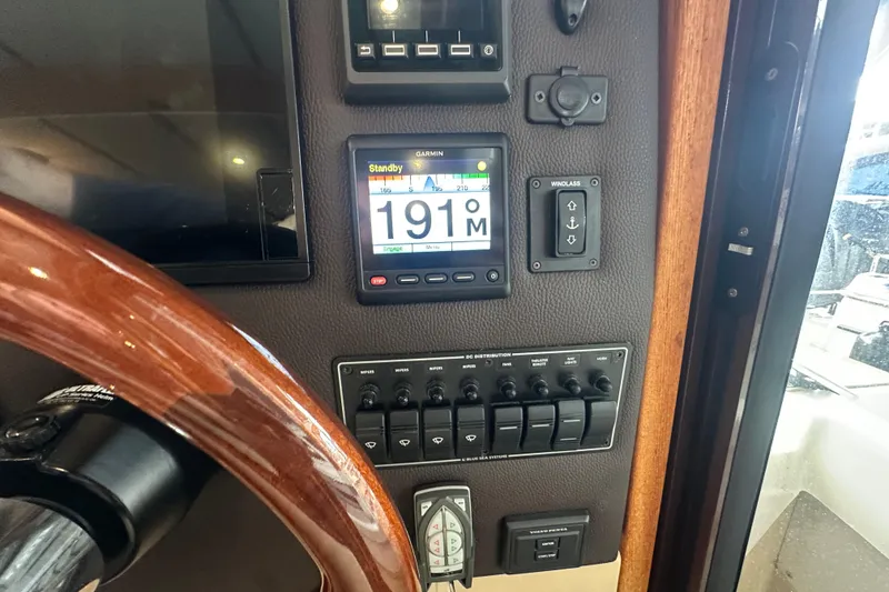 Slide: The Image of 2018 Ranger Tugs R-31 S helm with Garmin display and control panel. - 38