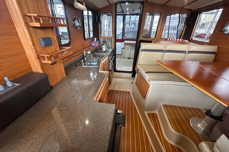 Slide: The Image of Interior of 2018 Ranger Tugs R-31 S, featuring a modern kitchen and dining area. - 39