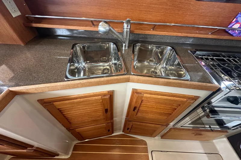 Slide: The Image of 2018 Ranger Tugs R-31 S galley with dual sinks and wooden cabinetry. - 41
