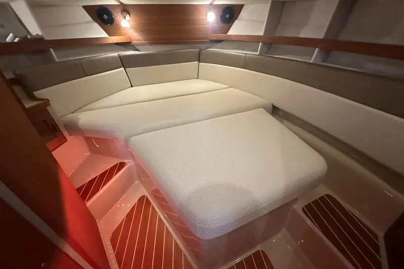 Slide: The Image of 2018 Ranger Tugs R-31 S interior cabin with cozy seating and wooden flooring. - 44