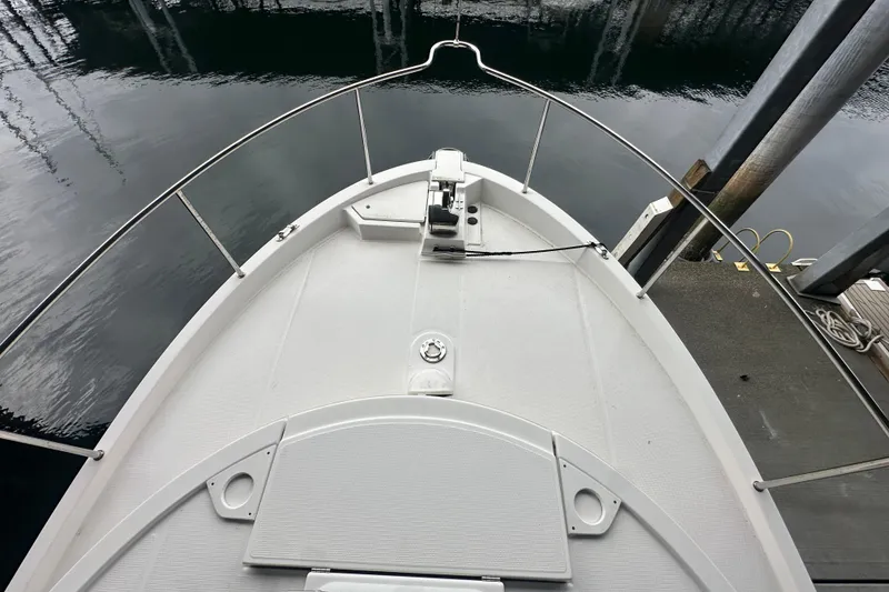 Slide: The Image of Bow view of 2018 Ranger Tugs R-31 S docked at marina. - 49