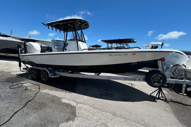 The Image of 2022 Pathfinder 2600 TRS boat on trailer under clear blue sky. - 0