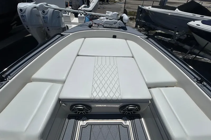 Slide: The Image of 2022 Pathfinder 2600 TRS boat with cushioned seating and dual outboard motors. - 12