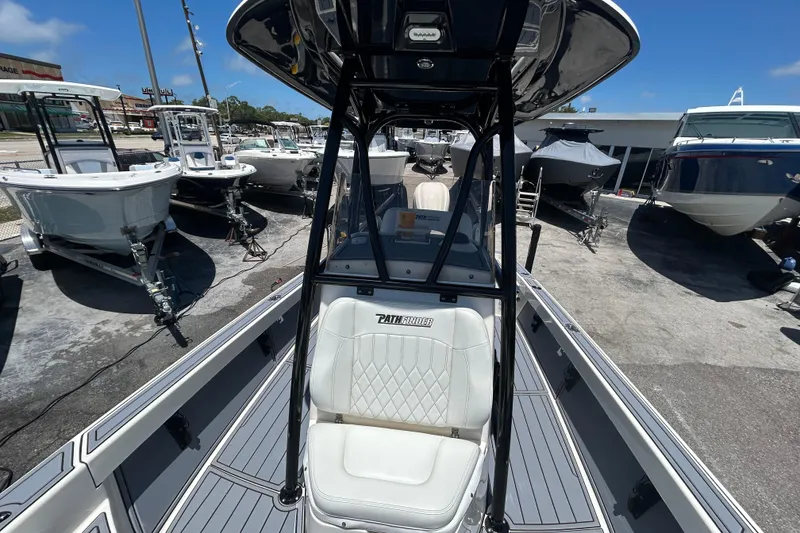 Slide: The Image of 2022 Pathfinder 2600 TRS boat displayed at a dealership, surrounded by other boats. - 13
