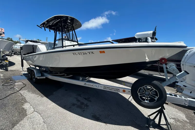 Slide: The Image of 2022 Pathfinder 2600 TRS boat on trailer under clear blue sky. - 17