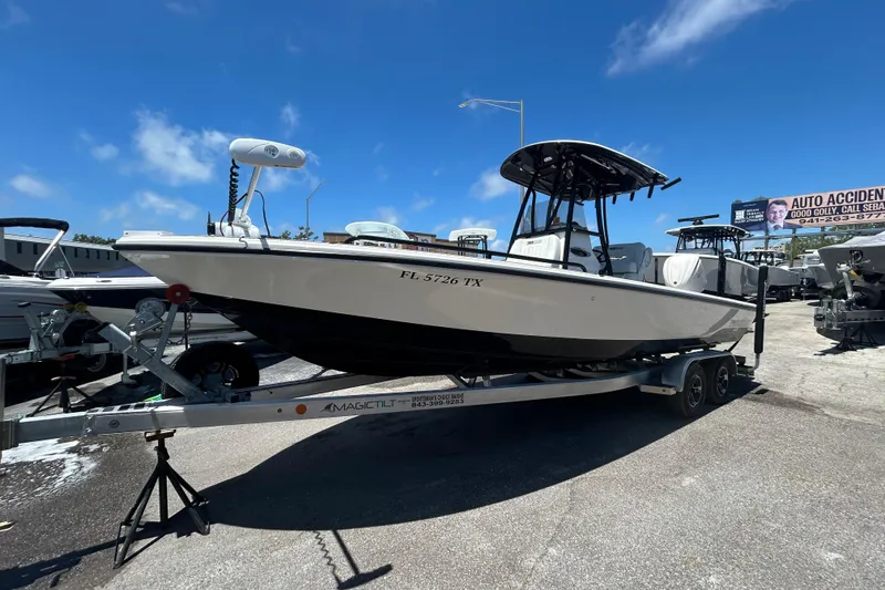 Slide: The Image of 2022 Pathfinder 2600 TRS boat on trailer under clear blue sky. - 2