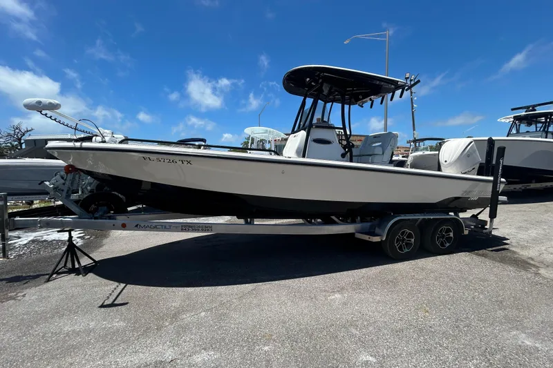 Slide: The Image of 2022 Pathfinder 2600 TRS boat on trailer under clear blue sky. - 3
