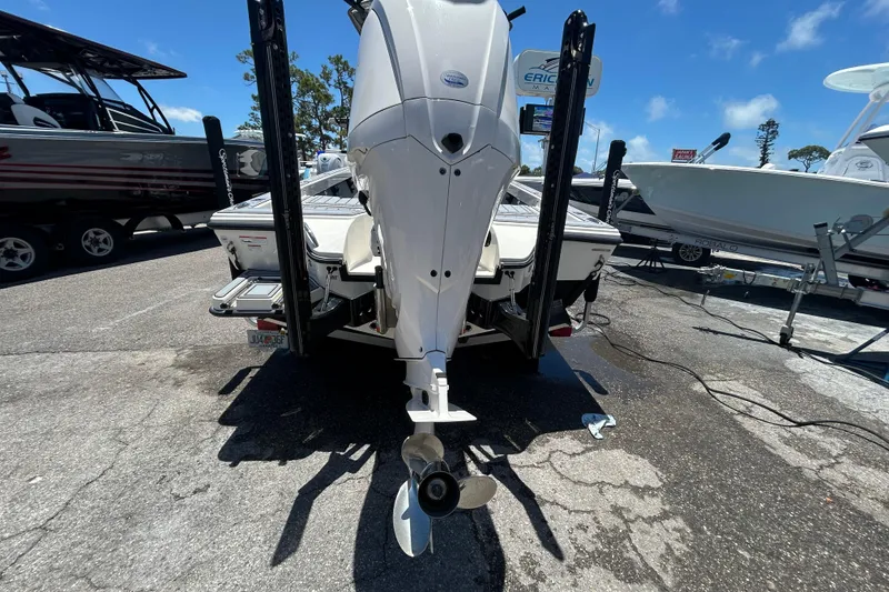 Slide: The Image of 2022 Pathfinder 2600 TRS boat with outboard motor, parked on a sunny day. - 6