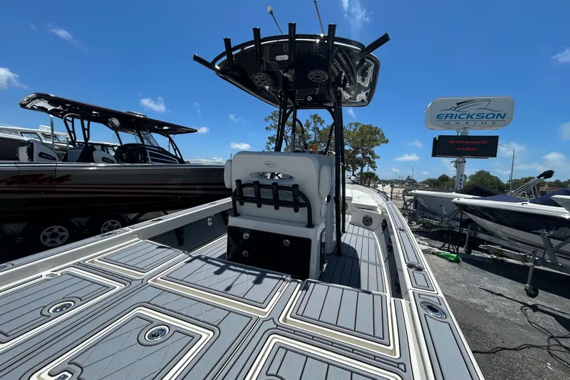 Slide: The Image of 2022 Pathfinder 2600 TRS boat at Erickson Marine dealership under clear blue sky. - 7