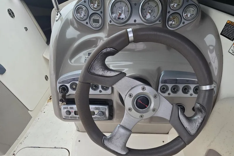 Slide: The Image of Steering console of a 2008 Maxum 2400 SR3 boat with instruments. - 3
