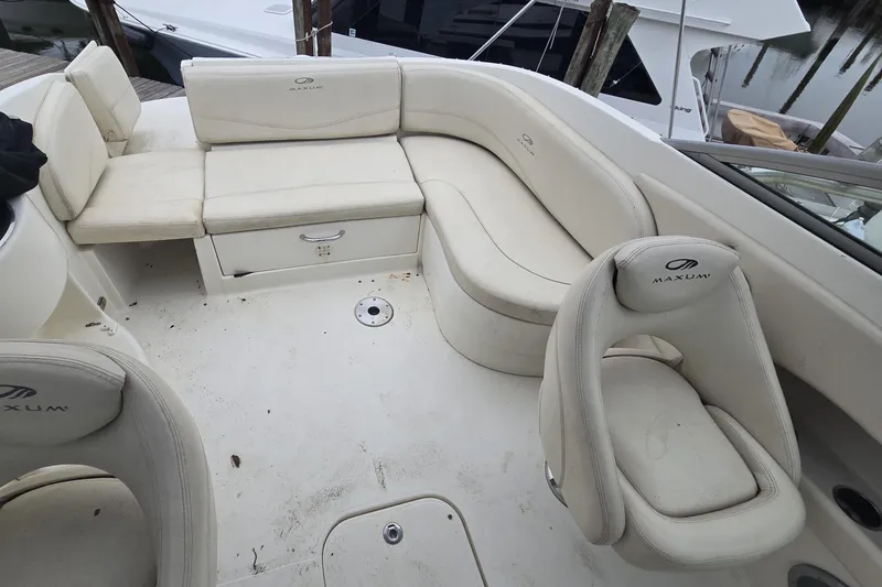 Slide: The Image of 2008 Maxum 2400 SR3 boat interior with white seating and storage compartments. - 5