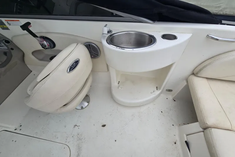 Slide: The Image of Interior of a 2008 Maxum 2400 SR3 boat featuring seating and a built-in sink. - 6