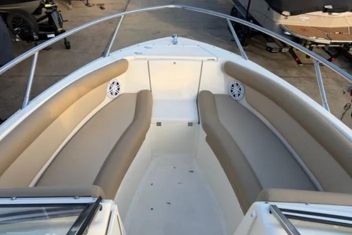 Slide: The Image of 2019 Scout 225 Dorado boat interior with beige seating and stainless steel railings. - 2