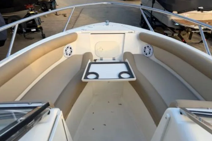 Slide: The Image of 2019 Scout 225 Dorado boat interior with beige seating and cup holders. - 3