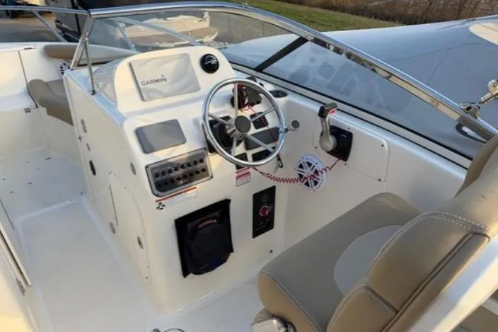 Slide: The Image of 2019 Scout 225 Dorado boat cockpit with steering wheel and Garmin navigation system. - 5