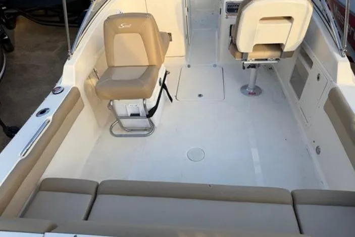 Slide: The Image of 2019 Scout 225 Dorado boat interior with beige seating and spacious deck layout. - 8