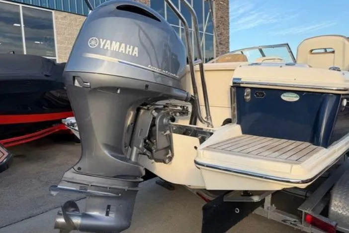 Slide: The Image of 2019 Scout 225 Dorado boat with Yamaha outboard motor, parked outdoors. - 9