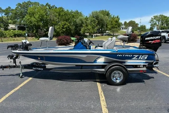 Slide: The Image of 2018 Nitro Z18 fishing boat with Mercury engine, parked outdoors on a sunny day. - 12