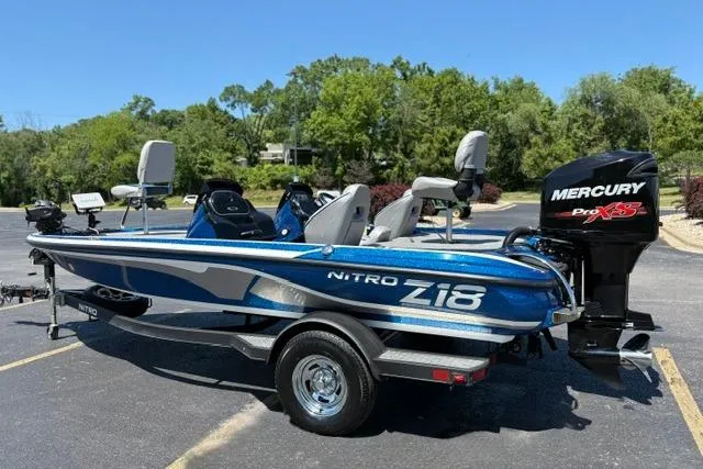 Slide: The Image of 2018 Nitro Z18 boat with Mercury Pro XS engine, parked outdoors on a sunny day. - 14