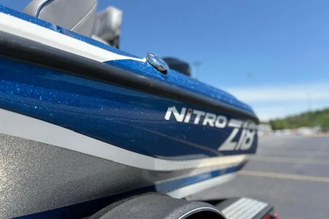 Slide: The Image of 2018 Nitro Z18 boat with blue and white detailing, parked outdoors. - 16