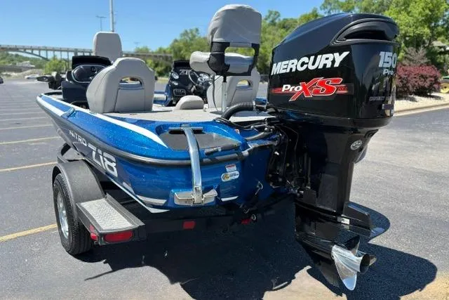 Slide: The Image of Blue 2018 Nitro Z18 boat with Mercury Pro XS 150 engine, parked on a trailer. - 20